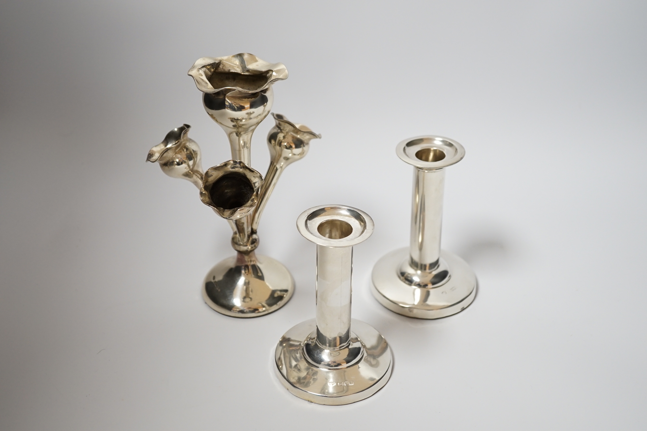 A pair of Edwardian silver mounted dwarf candlesticks, by William Hutton & Sons, London, 1904, 11cm, weighted, together with a late Victorian small silver centrepiece with four receivers.